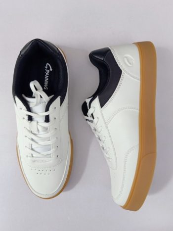 White and black sneaker with brown sole